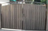 Decorative RV gate with dark brown frame and rustic cedar composite privacy slats