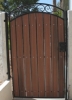 arched pedestrian gate showing redwood composite and black steel
